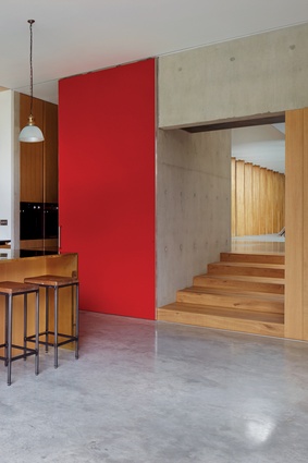 Colour accents throughout the house provide a strong contrast with the timber and concrete material palette. 