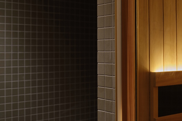 This rich contrast of the tiles to the warm cedar saunas creates a serene haven — carefully designed as a retreat from the outside world, inviting relaxation and calm.