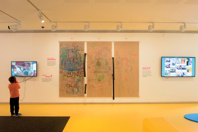 Three large panels of brown paper make up the drawing wall, which gets changed out when finished, photographed, uploaded and then streamed on a screen next to the wall.