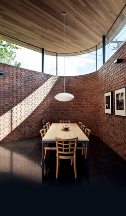 Clerestory windows draw light inside while the brick walls maintain privacy and protection from the busy street.