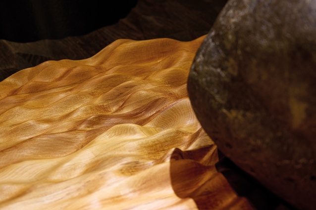 The mouri stone Te Uiraroa – igniting the mouri of Tākina – sits on a bed of rippling rimu, designed by Studio Pacific and CNC-crafted by Makers Fabrication. This lightning stone was gifted from Te Ati Awa and blessed by kaumatua Kura Moeahu.
