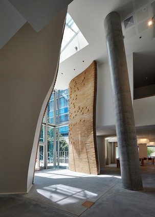 A trunk-like column resonates with Gehry’s concept of building a treehouse, as a curvaceous flow of bricks continues his masterclass in working from the inside out. 