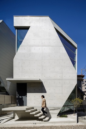 This home in central Tokyo, Japan was designed by Atelier Tekuto. Volcanic ash is mixed into the concrete shell of the angular house, for increased strength and durability.