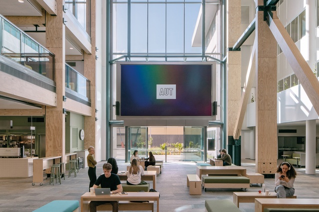 A large screen at the southern end of the building provides an atmosphere of ambient university advertising.