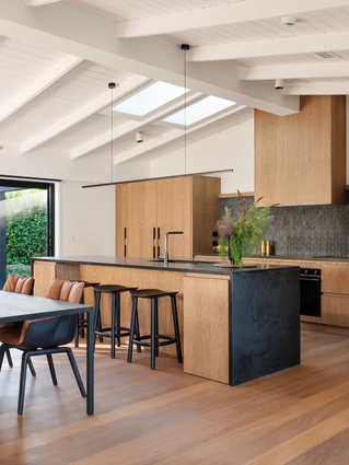 A soft palette of timbers with black accents creates a contemporary look at Lake Rotoiti.