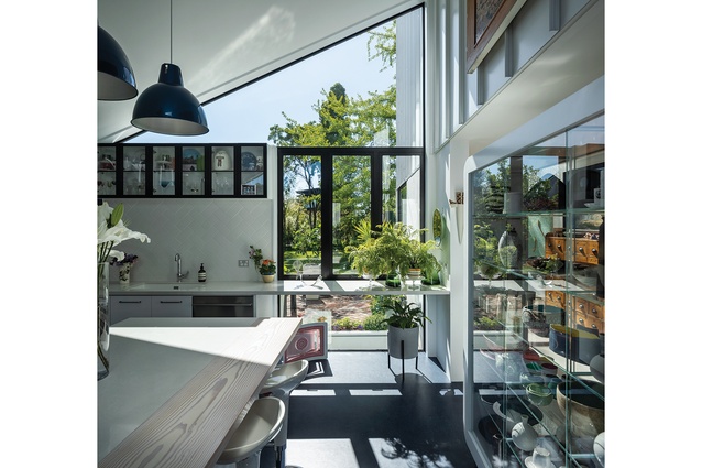 Kitchen and living areas step north from the main double-height space and out into the garden.