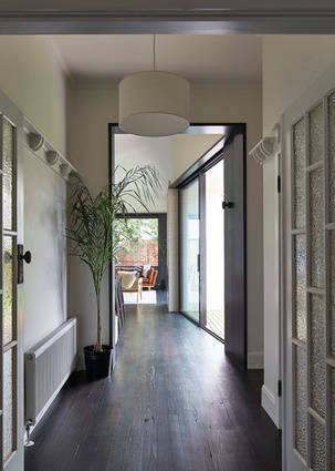 An oversized doorframe “portal” signifies a move from the existing part of the house into the new part.