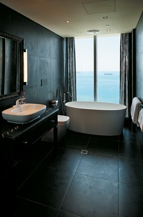 A typical suite with views out to sea from both bedroom and bathroom.