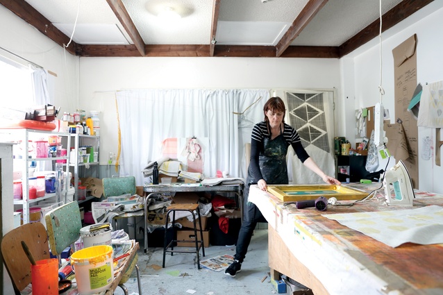 Katie Smith hand-printing fabrics in her design studio at the Corbans Estate Arts Centre in Auckland.