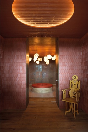 A second vestibule is clad with painted shingles, reminiscent of traditional red roof tiles on Swiss chalets. The sculpted chair is by Roberto Matta (1970s).