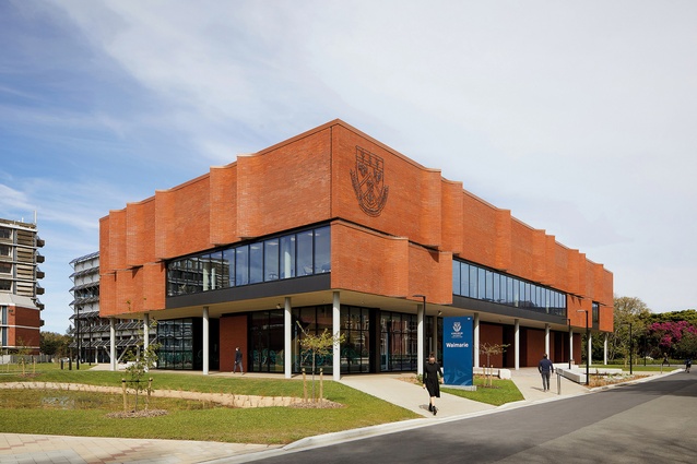 The two-storey teaching volume is augmented in scale by the articulation of the upper brick cladding and a generous parapet.