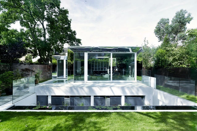 Mirrored window and door reveals allow the home’s edges to ‘disappear’ into the leafy garden.