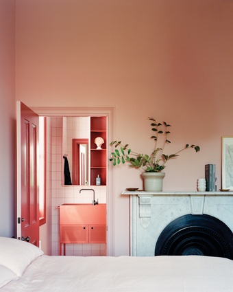 In the existing house, the main bedroom is awash with pattern, pinks and plush crimson carpet.