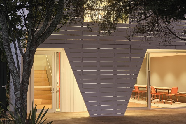 The design and construction process avoided the removal or trimming of any trees, despite existing trees touching the resulting new building on three sides.