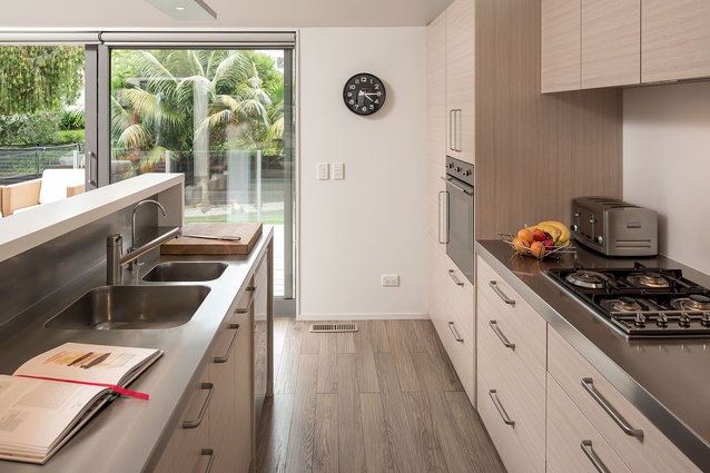 An upstand on the island ensures all kitchen clutter remains out of sight of the living areas.