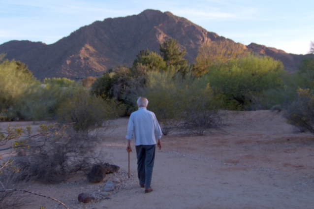 Paolo Soleri walking in the desert surrounding his home in Arizona.