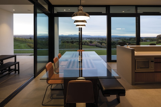 Davey Lighting factory pendants from ECC hang above a custom-made dining table from John Erdos Gallery. 