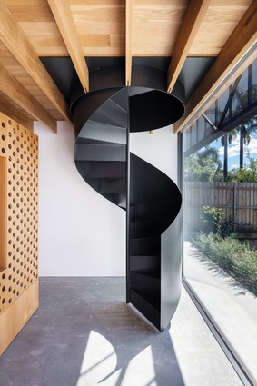 A spiral staircase at the entry to the home signals spatial tactics that unfold as you move throughout the house.