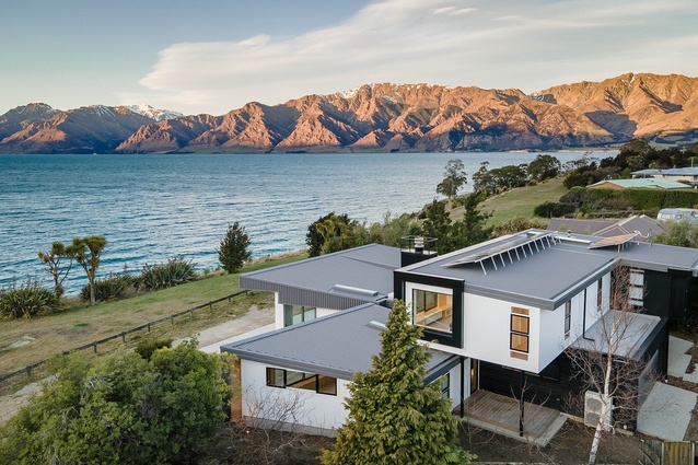 The house in its setting beside Lake Hawea in the South Island.