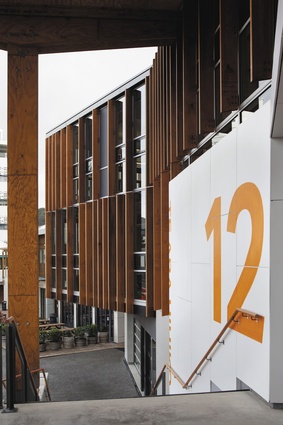 Timber screening and bold typography near the main entrance.