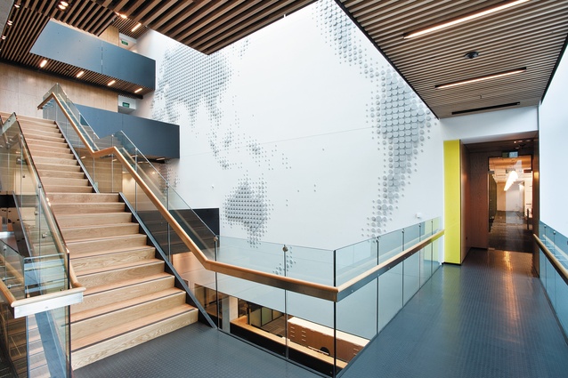 The atrium’s  feature wall depicts a map of the world comprising of circular plastic discs.