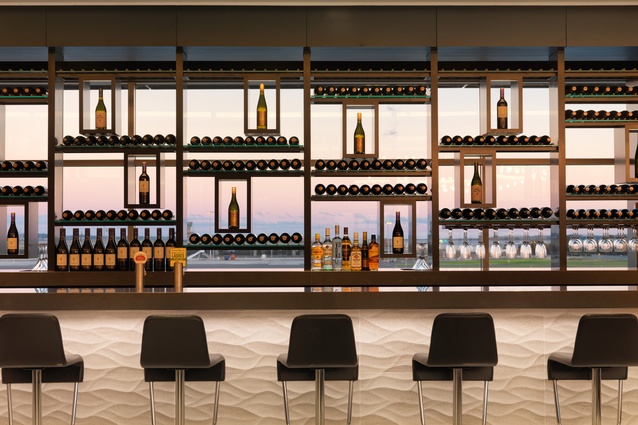 Framed views through to the taxiway and beyond, and an extensive selection of premium New Zealand vintages, make the Wine Wall the central space of the Sydney Koru Lounge. 