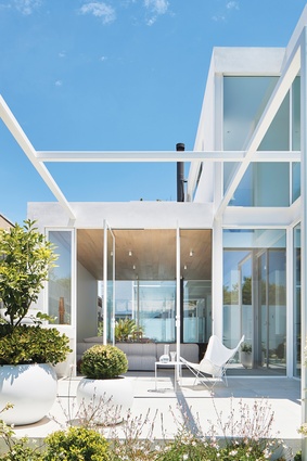 A central courtyard, open to the sky, both connects and separates the house’s tripartite layout.