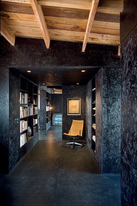 Walls, shelving and ceiling in this study area are made from OSB stained black.