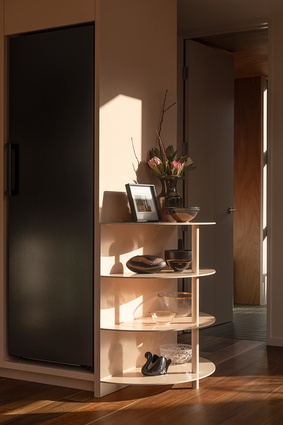 Sunlight is used to naturally showcase shelving throughout the downstairs. 