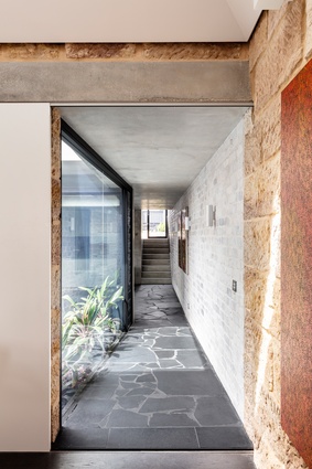 A concrete lintel above the doorway that leads to the home’s addition signals a material transition between old and new.