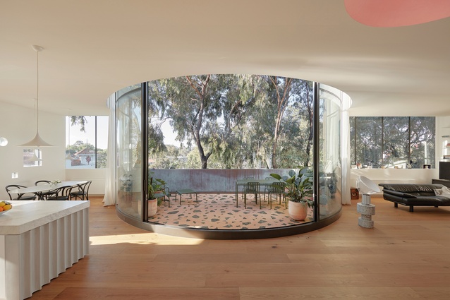 The penthouse’s glazed, curved courtyard is stunning in the way it blurs the line between inside and out.