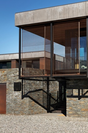Schist, board-formed concrete and Corten steel provide the external material palette. 
These materials are also carried through to the interior.