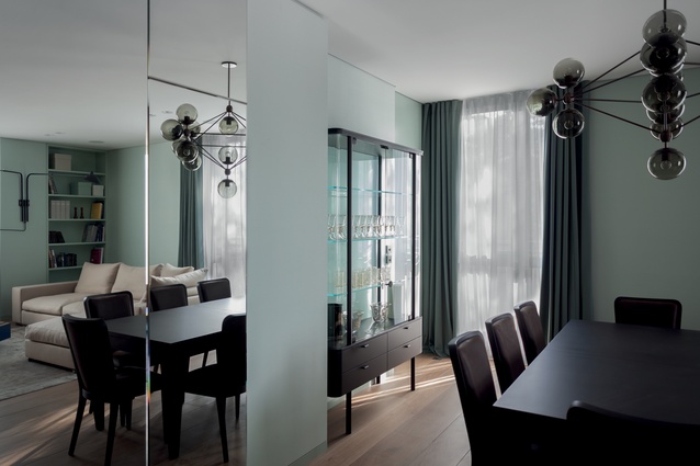 A Roll & Hill Modo chandelier with black smoke glass pendants hangs above the dining table.