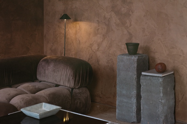 A moody space made warm through material and colour choice. The couch was sourced by PH Digital CEO, Christine Kearney.