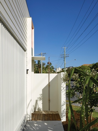 The entry to the home features an outdoor shower for rinsing off after visiting to the beach.
