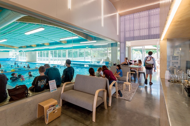 Along the front of the building, a café and a parents’ lounge are separated from the pool by a glass wall, allowing parents to view their children having swimming lessons.