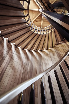 A cedar-clad drum contains the staircase, which is the one solid form in the building. 