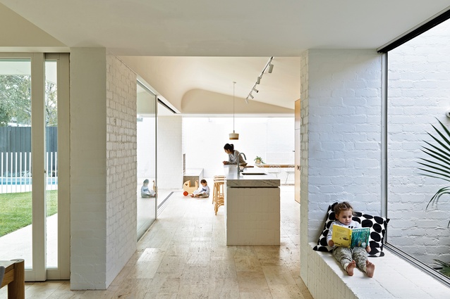 Lightly bagged and painted brickwork is seen throughout the home from the walls to the window seat and the kitchen’s island bench.