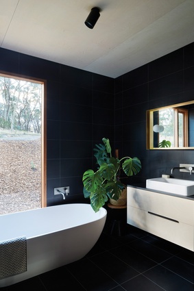 Moments of saturated colour rest on a base of neutral tones, such as the black porcelain tiles of the upper pavilion’s bathrooms.