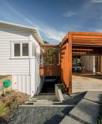 A breezeway connects the existing and new structures; the joinery combines cedar sashes with totara frames.
