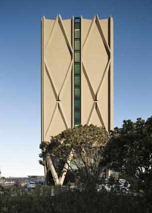 The narrow profile of the northern facade reveals the tall, thin form of the building.