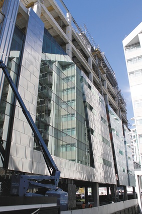 The west elevation curtainwall panels are clad with distressed stainless steel panels.