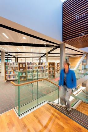 View from the top of the stairs towards the library stacks on the second storey. 