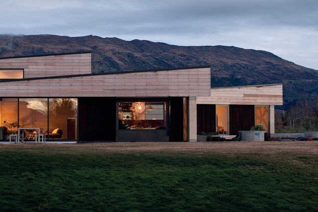 Rammed-earth House: The front elevation features a stepped roofline, mimicking the dramatic local landscape.