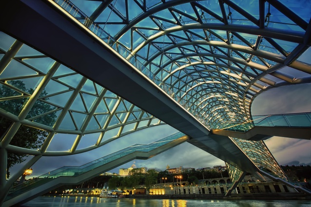Bridge of Peace, Tbilisi, Georgia. The bow-shaped pedestrian bridge opened in 2010. The curvy steel and glass canopy top shimmers with an interactive light display at night.