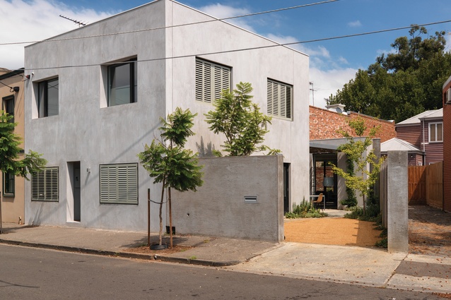 The house presents a flattened facade to the street and the bare render coating lends it a Mediterranean feel.

