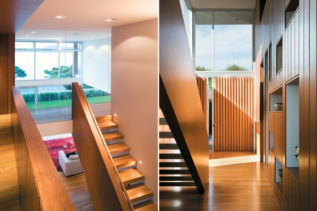 The stair landing makes a feature of the double-height space  above the living area; Recessed cubby hole in the living area walls display family artefacts. 