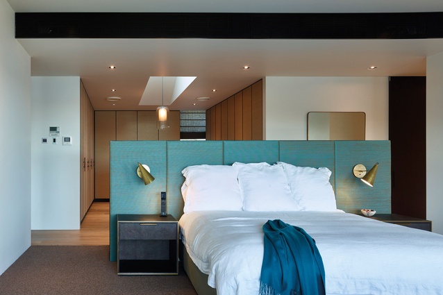 The master bedroom looks out to the harbour with a large walk-in-robe behind