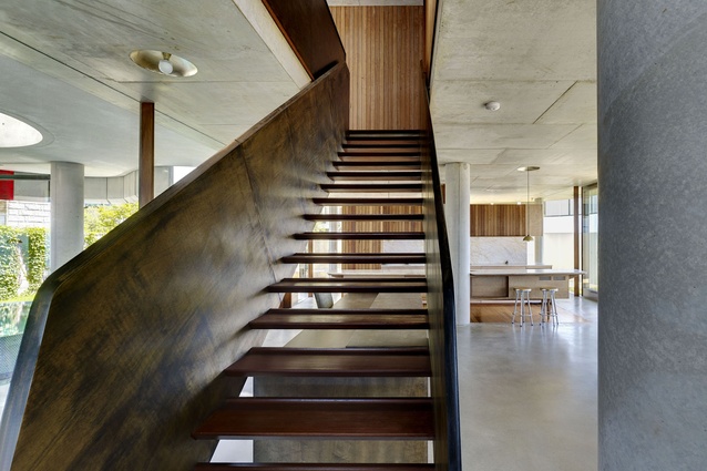 A custom staircase punctuates the otherwise open-plan ground level. 