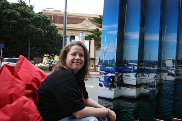 Emma Harrison next to her 3-metre-long lenticular slice of Wellington's waterfront.